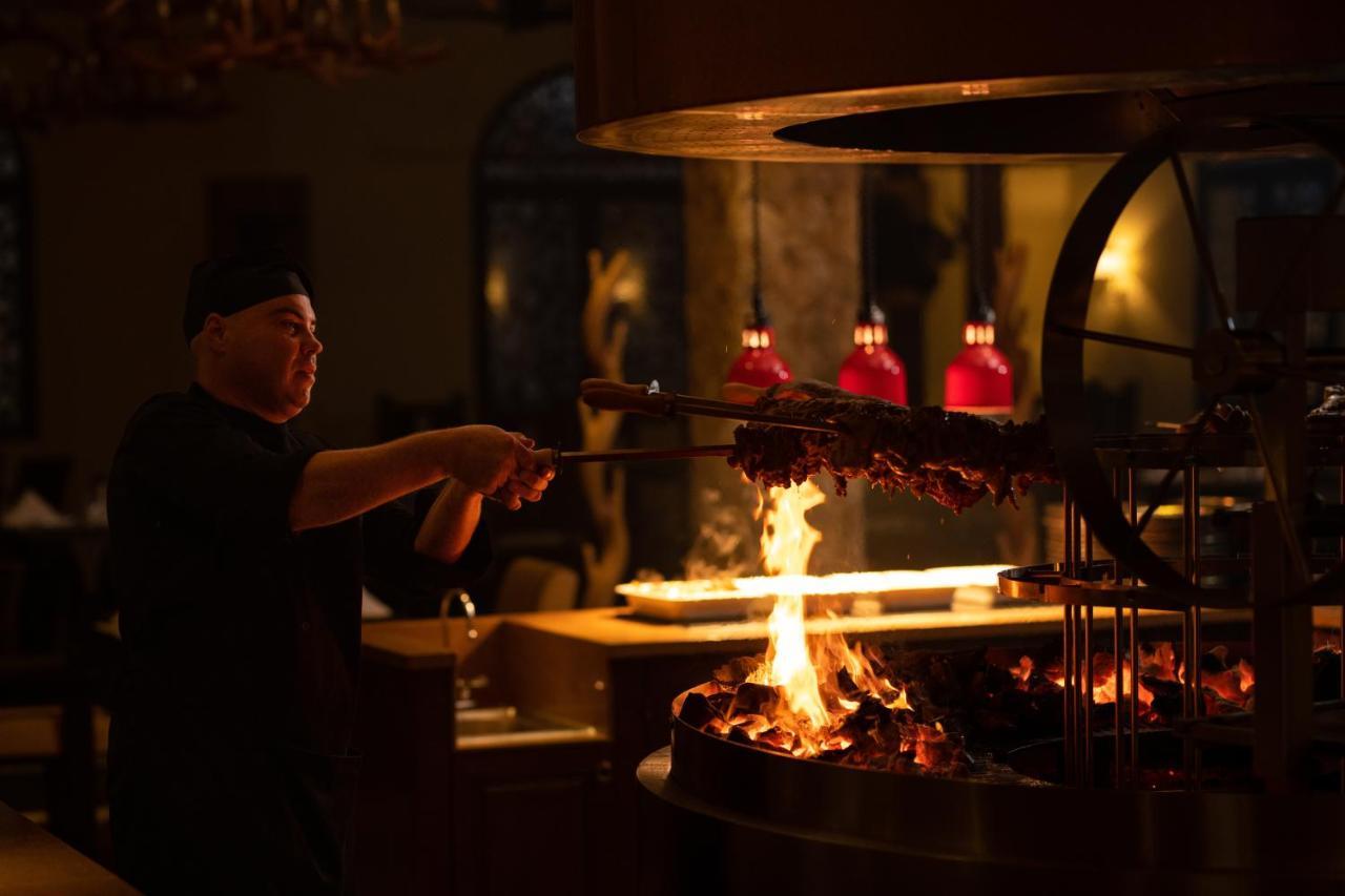 The Mora Zanzibar Hotel Matemwe  Exterior photo A chef cooking over a wood-burning grill